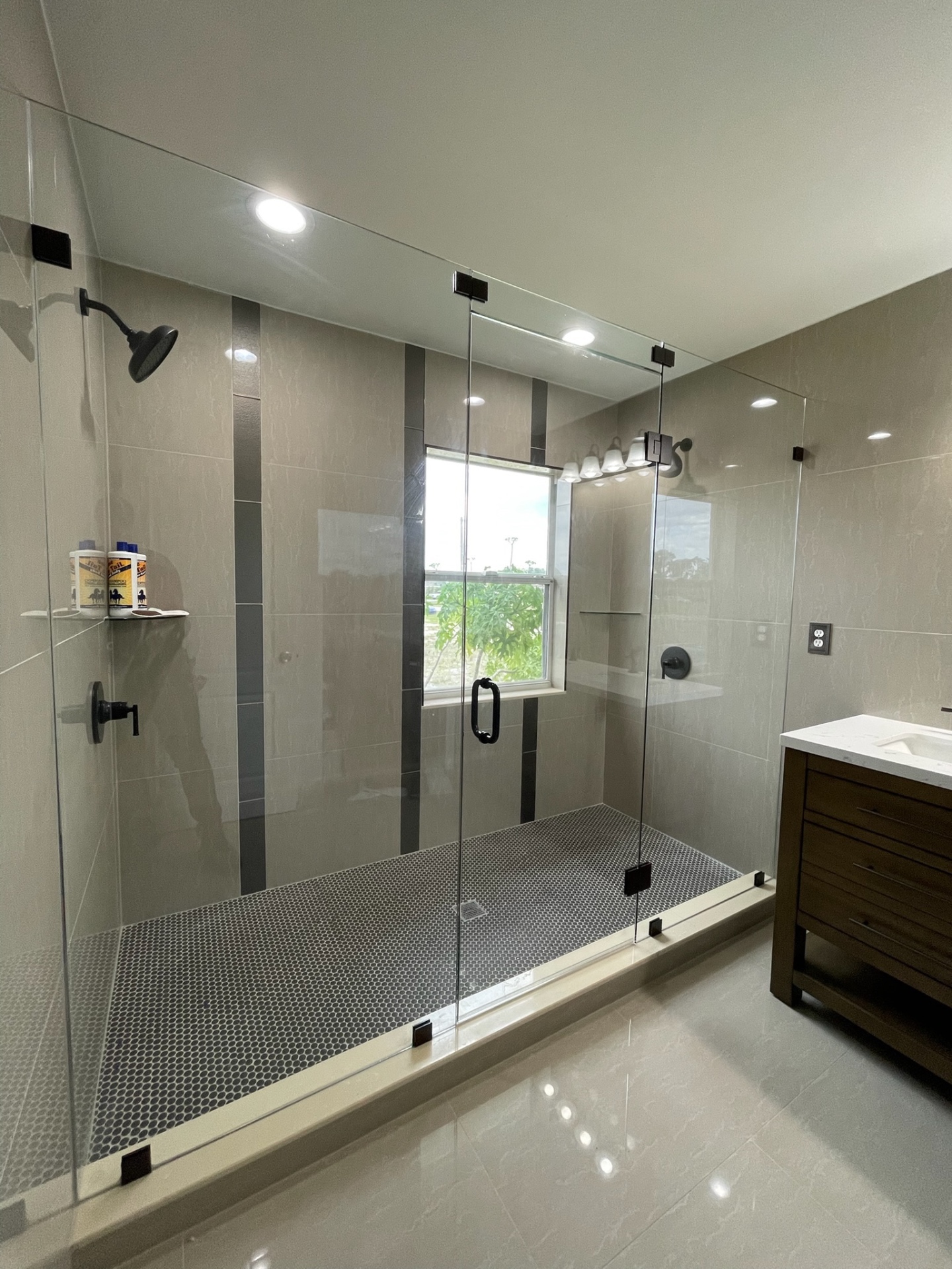 Frameless shower enclosure