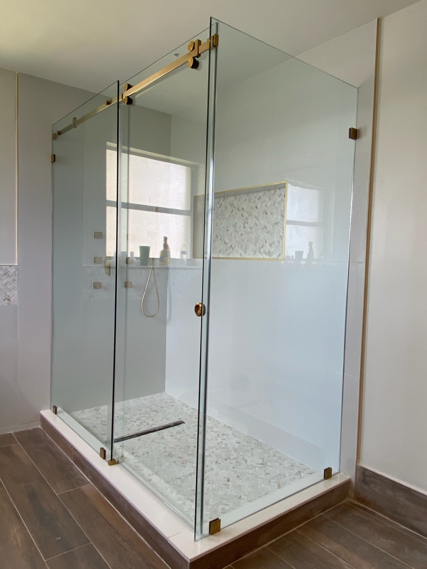 Frameless shower enclosure