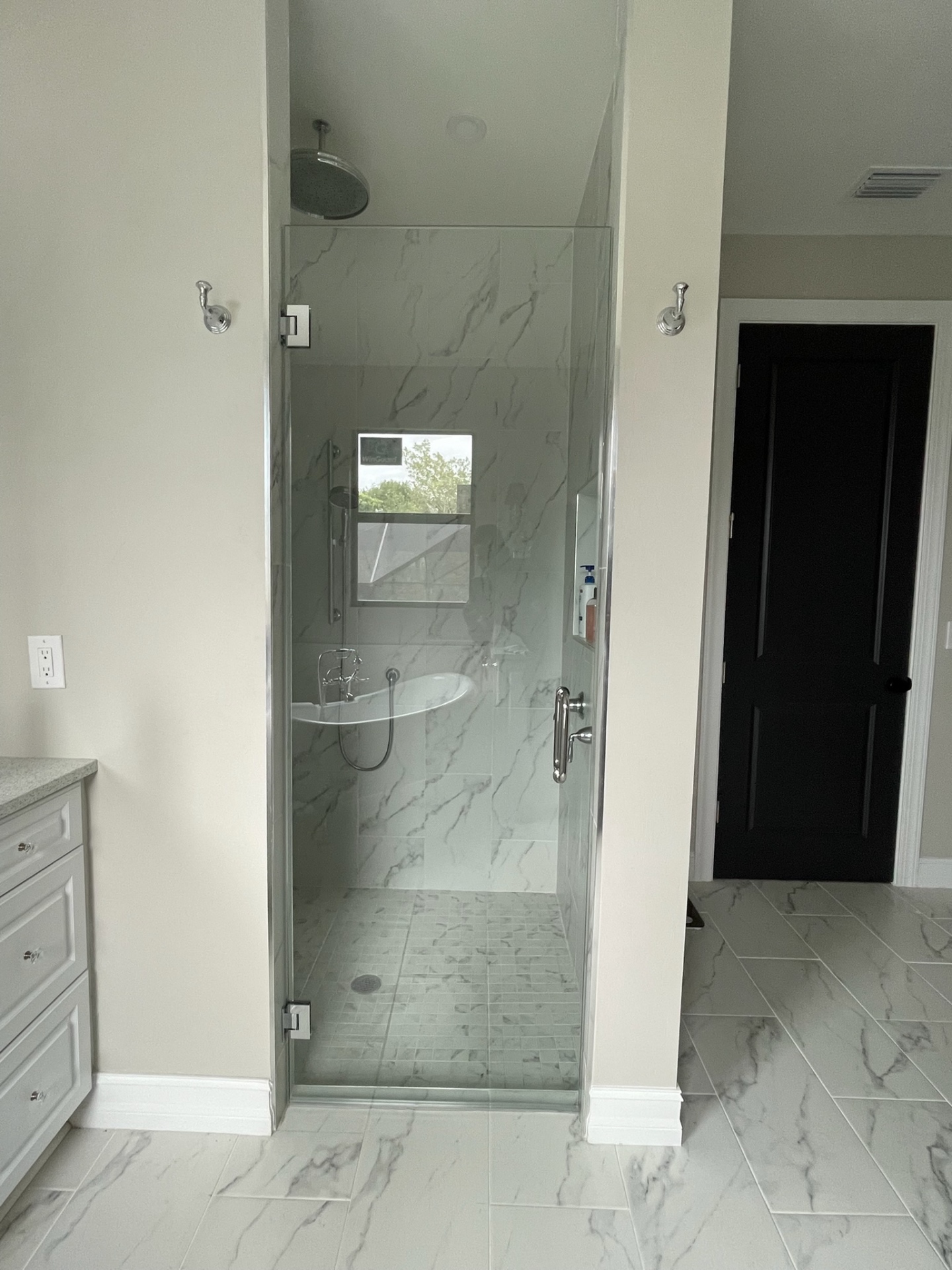 Frameless shower enclosure